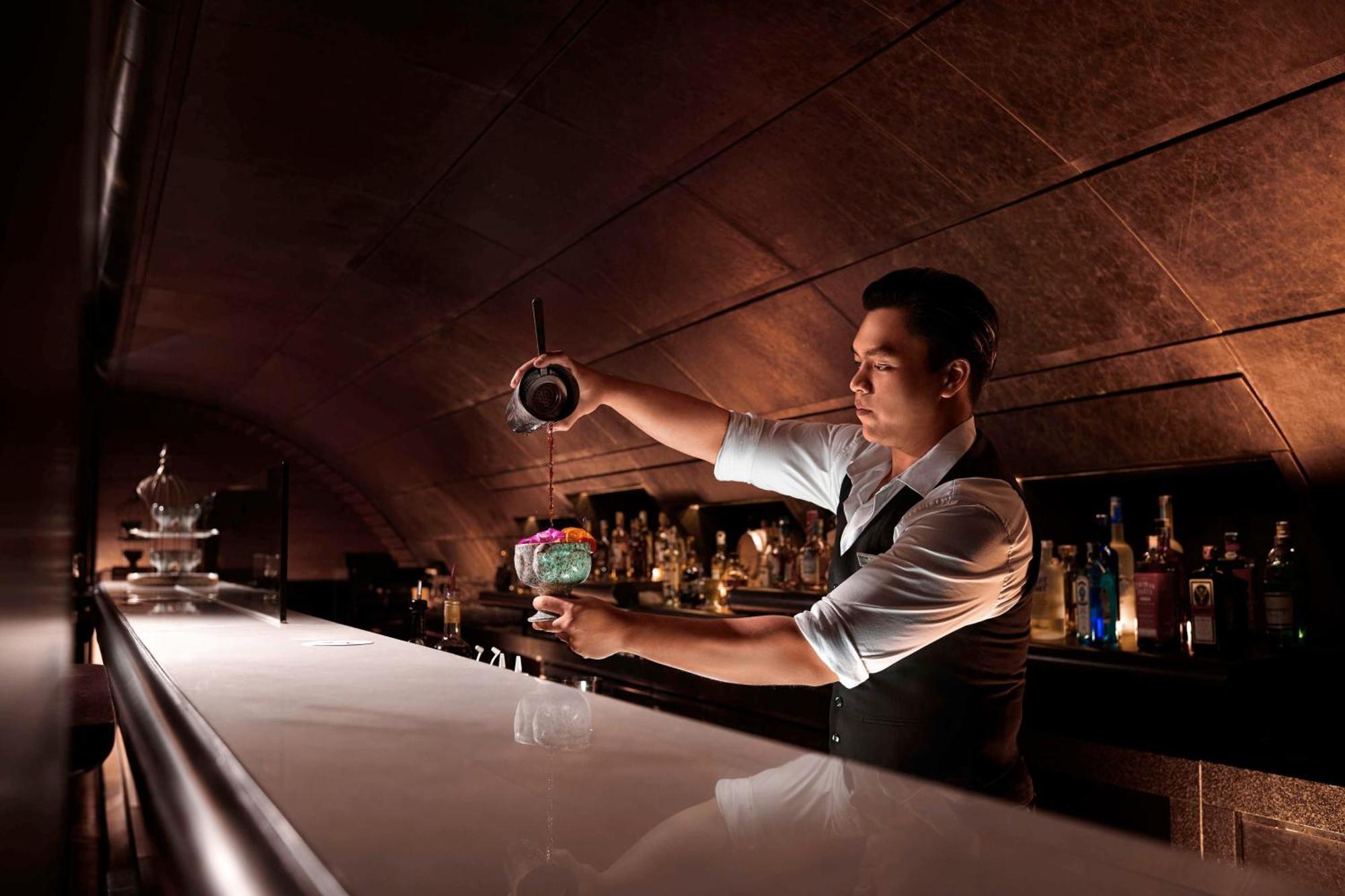 Hilton Kuala Lumpur Hotel Exterior photo A bartender at work